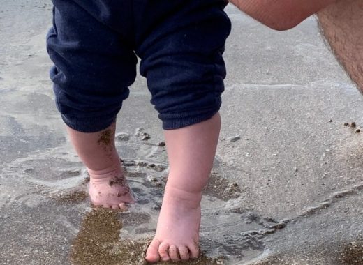 petits pieds de bebe dans le sable de plage de Normandie